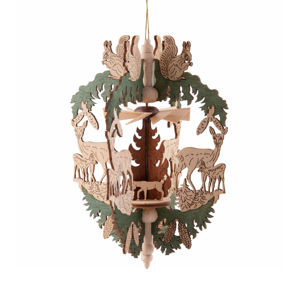 A wooden hanging decoration depicting a pyramid with deer and a hunter in the center, with green and brown colors and intricate detailing.