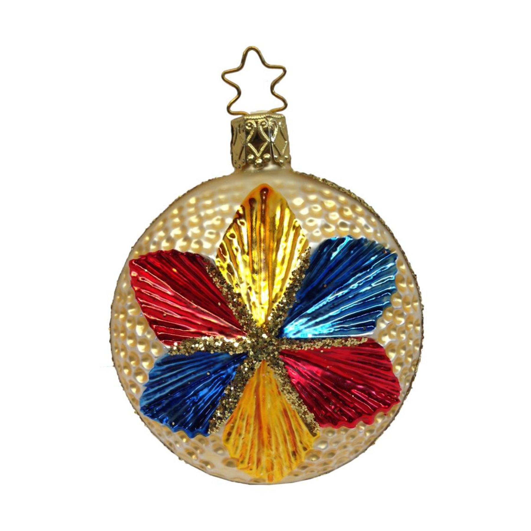 A multicolored shimmering star-shaped ornament with red, blue, yellow, and green sections with a gold star top for hanging by Inge Glas of Germany.