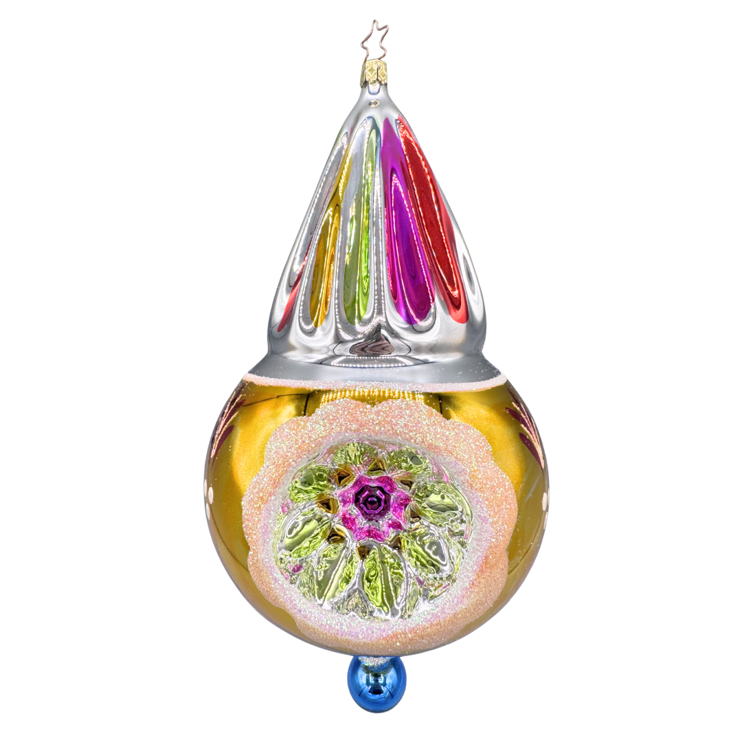 Decorative blown glass teardrop-shaped ornament with a very colorful stripe design at the top and a round reflector in the side of the round bottom.