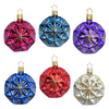 Set of six colorful geometric faceted Christmas ornaments with a gold star top for hanging by Inge Glas of Germany on a white background
