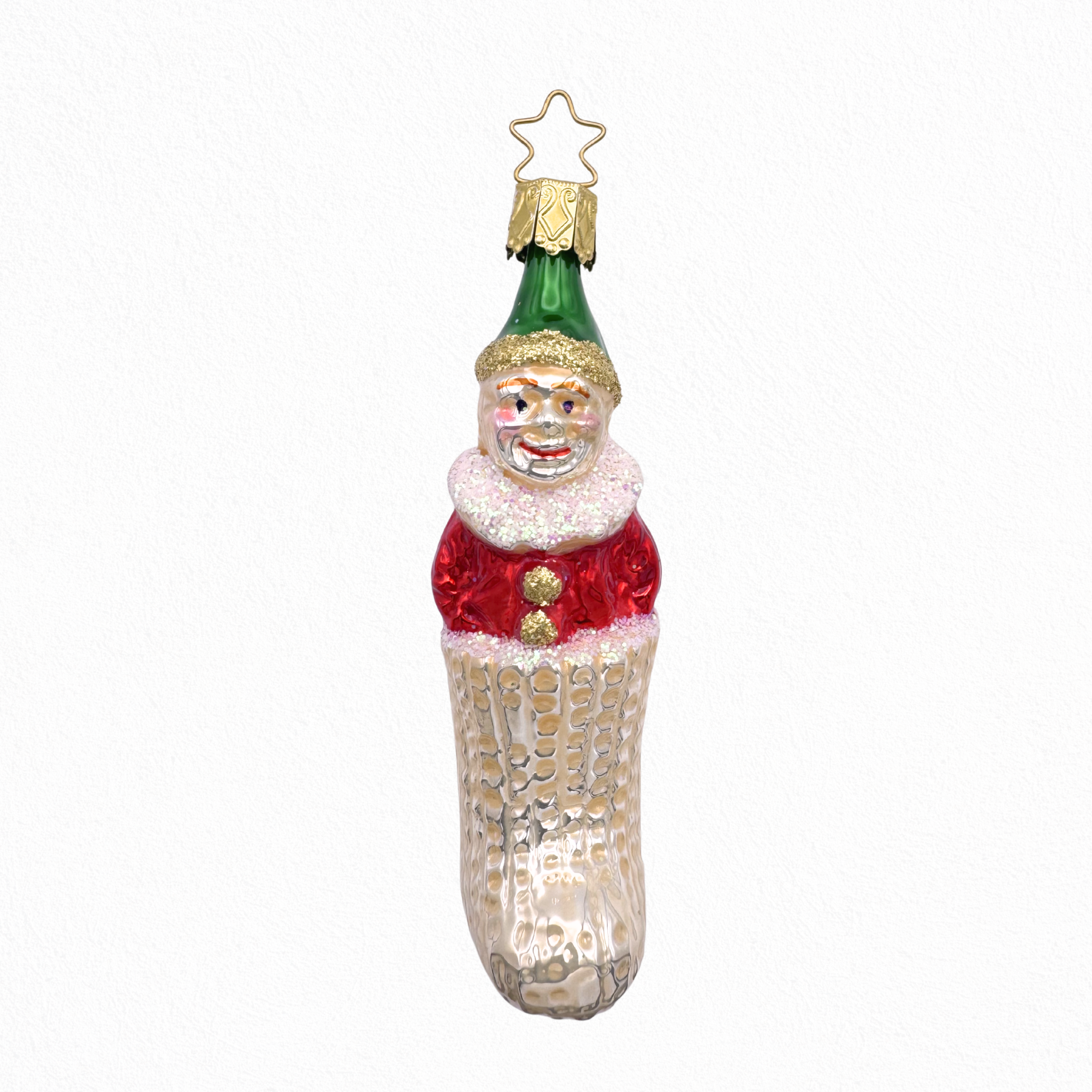 Decorative glass Christmas ornament of a green and red clown in an ivory stocking with a gold star top for hanging by Inge Glas of Germany.