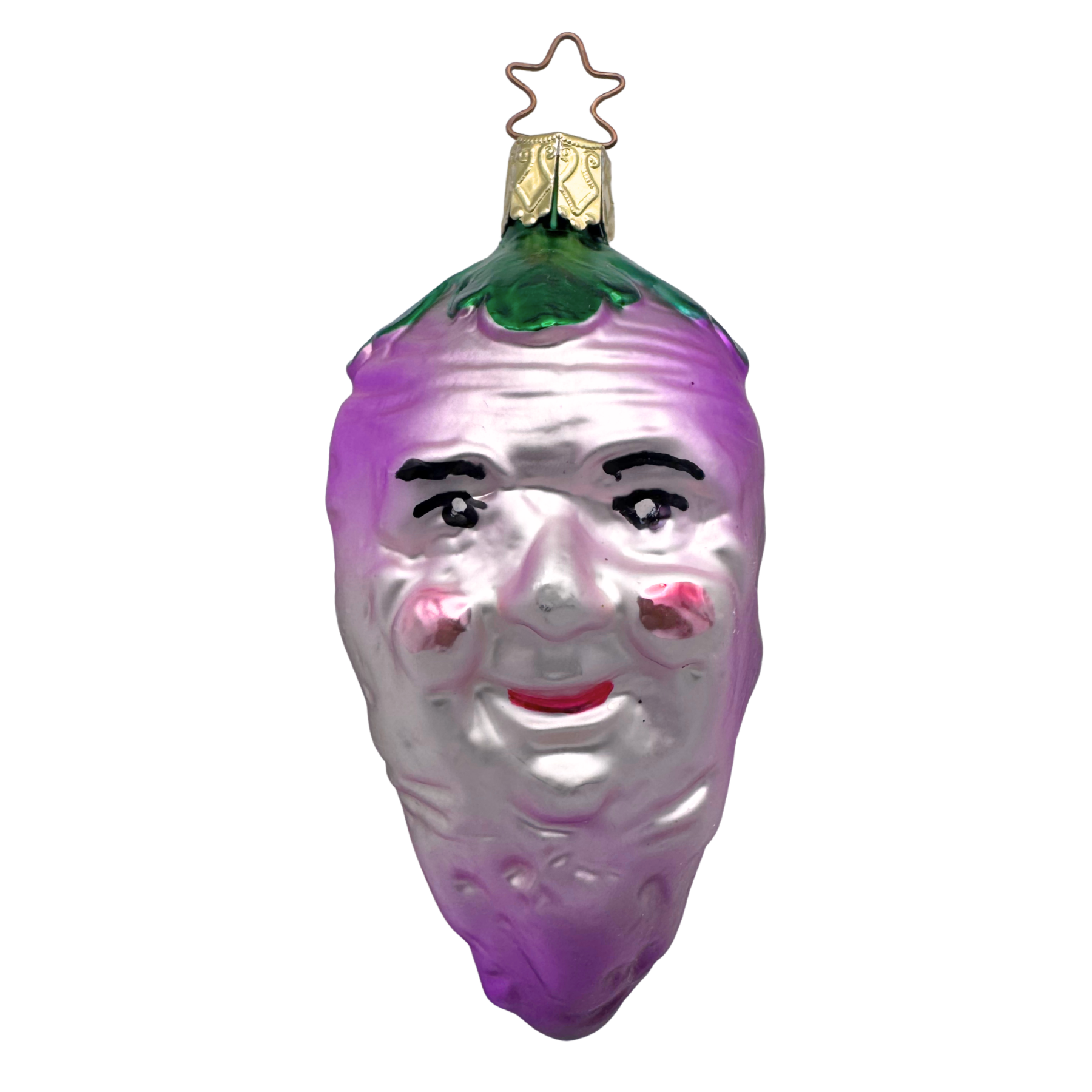 A glass ornament in the shape of a turnip with a face painted on it, predominantly purple in color with green at the top, and a gold star top for hanging by Inge Glas of Germany.
