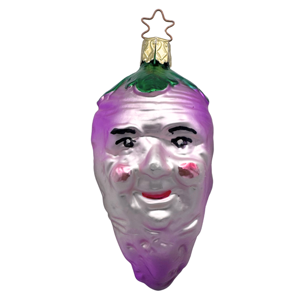 A glass ornament in the shape of a turnip with a face painted on it, predominantly purple in color with green at the top, and a gold star top for hanging by Inge Glas of Germany.