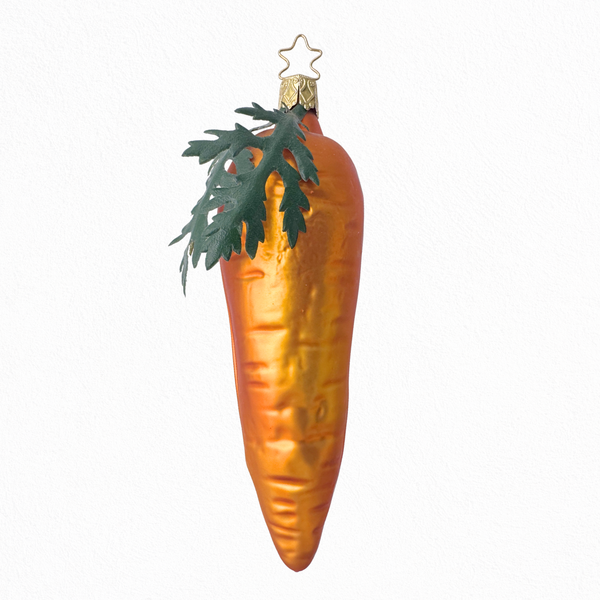 A large orange glass carrot ornament with leaf detailing, intended for seasonal decoration.