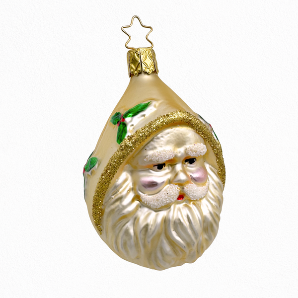 Glass ornament shaped like Santa's face with a beard, wearing a gold hat with holly leaves, on a white background and a gold star top for hanging.