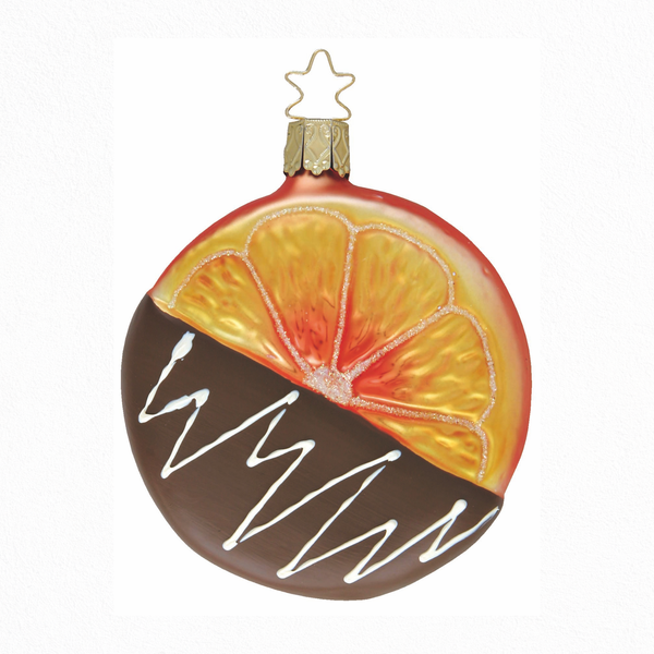Round glass Christmas ornaments with orange slice design dipped in milk chocolate with a gold star top for hanging on a white background