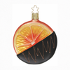 Round glass Christmas ornaments with orange slice design dipped in dark chocolate with a gold star top for hanging on a white background