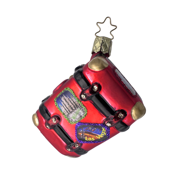 Decorative glass Christmas ornament
in the shape of a red suitcase with a gold star top for hanging by Inge Glas of Germany.