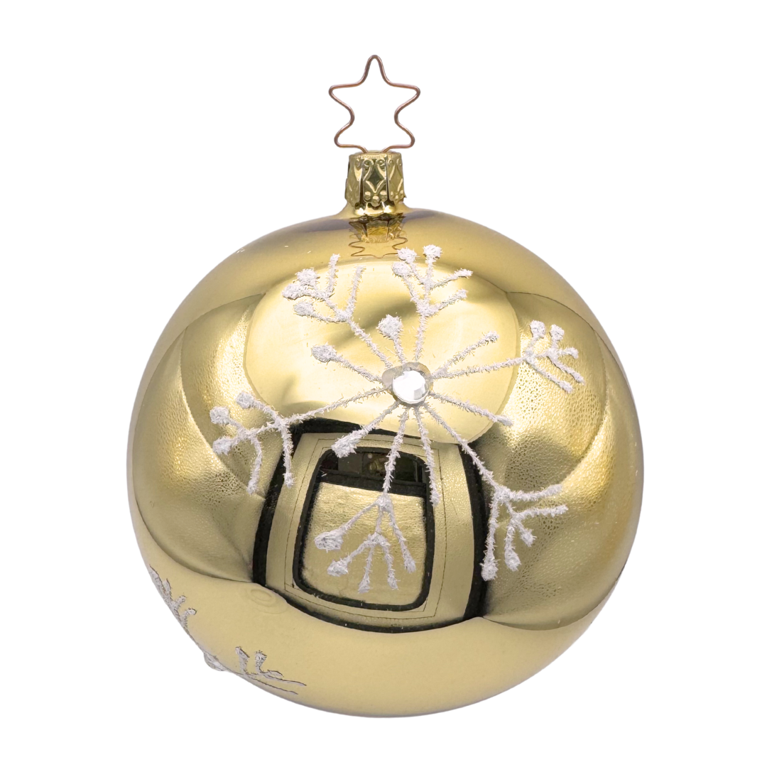 Gold Christmas ornament with snowflake design and star on top against a white background