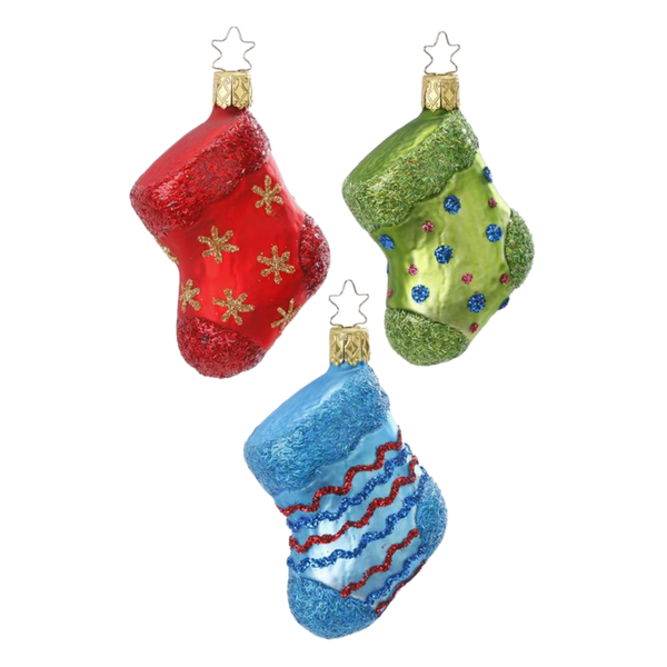 Three decorative glass stocking ornaments with a red, green, and blue color scheme, each adorned with snowflakes and gold stars.