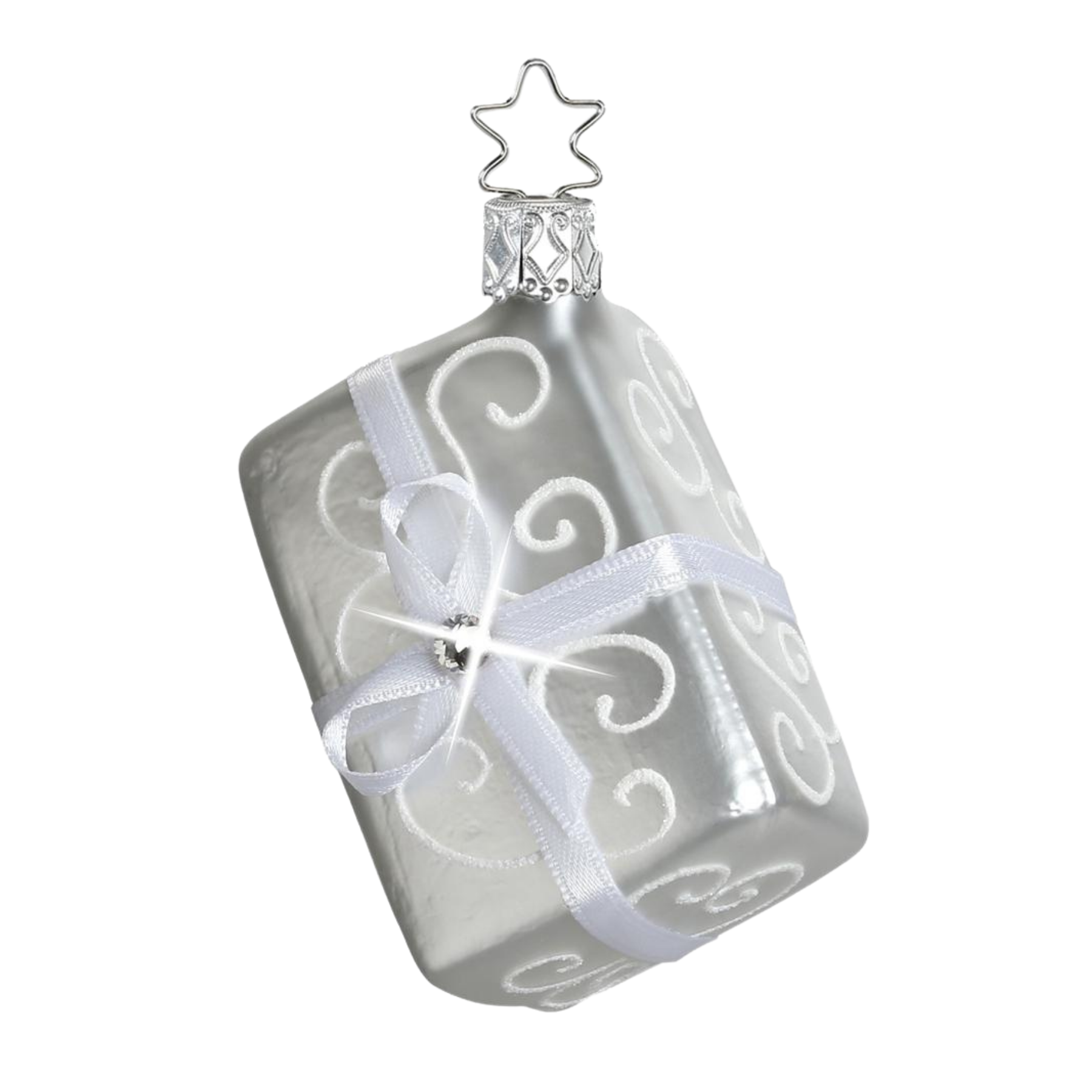Silver gift ornament with a star topper for hanging and a swirl design and a matte finish with white bow and gem accent.