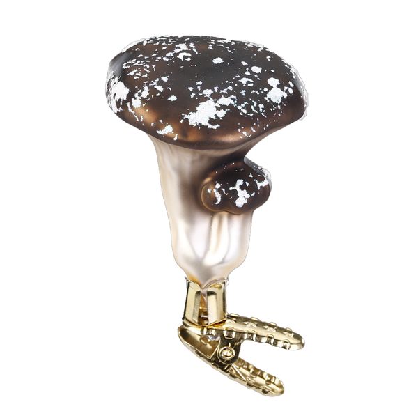 A mouth-blown and hand-painted glass ornament in the shape of a chanterelle mushroom, with gold accents, on a clip for hanging.