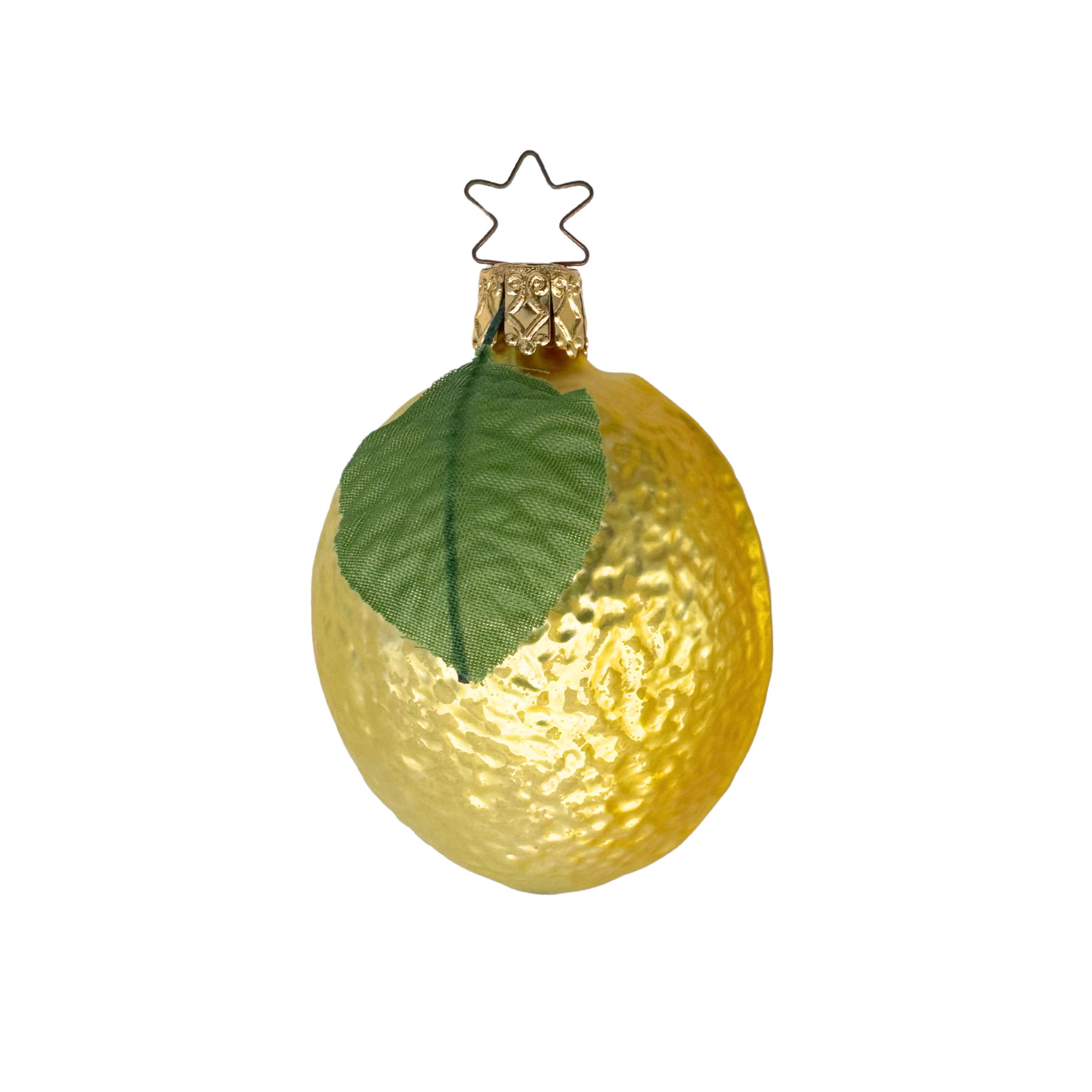 A glass ornament shaped like a lemon with a green leaf and star topper detail.