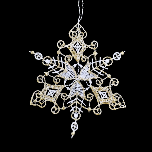 Decorative 6 pointed snowflake ornament with gold and white details on a black background
