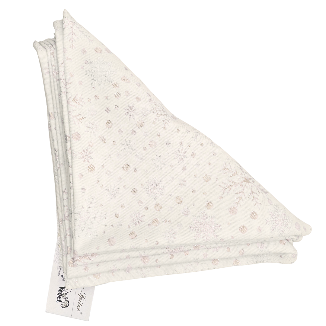 Folded white napkins, in a triangular shape with soft gold snowflake and dots pattern on a white background