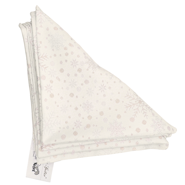 Folded white napkins, in a triangular shape with soft gold snowflake and dots pattern on a white background