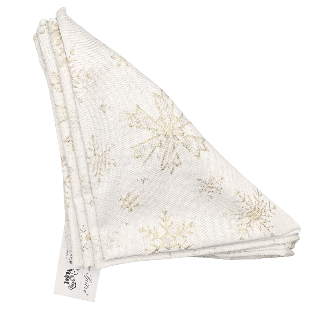 Folded white napkins, in a triangular shape with gold snowflakes pattern on a white background