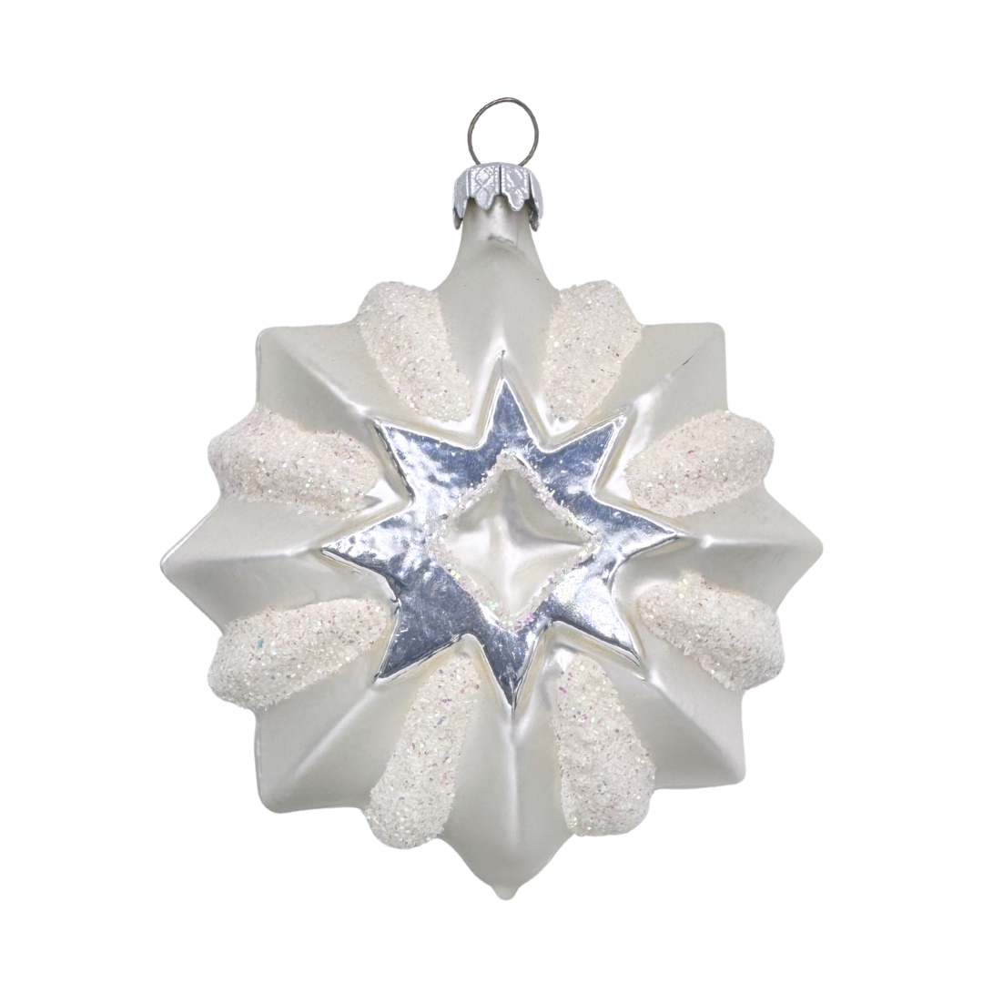 Decorative white and silver star-shaped ornament with white glitter accents on a white background
