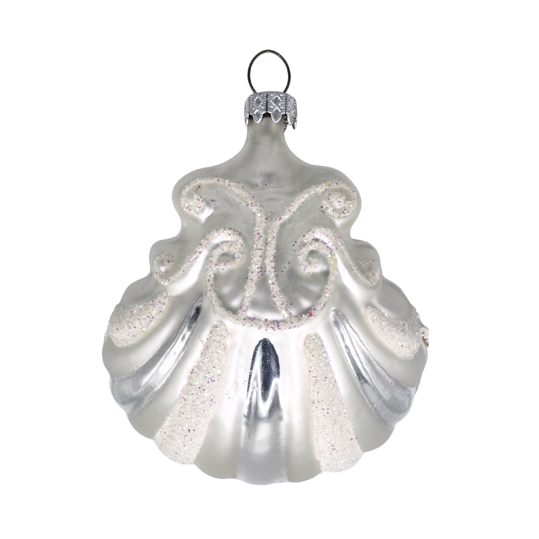 Decorative Christmas ornament in the shape of a shell with white and silver stripe design and glitter accents on a white background