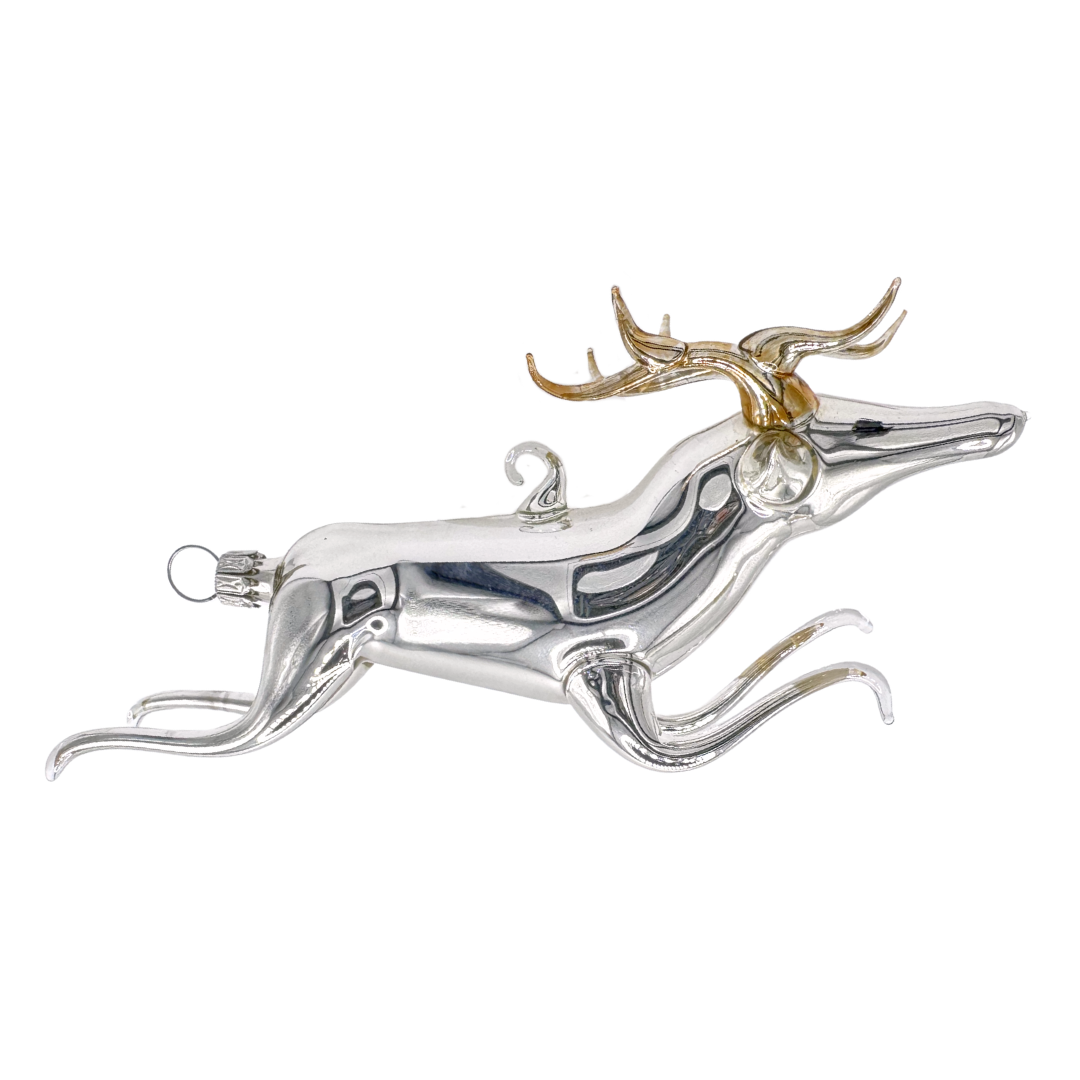 Artistic decorative ornament shaped like a deer with antlers mainly in silver, with gold antlers.