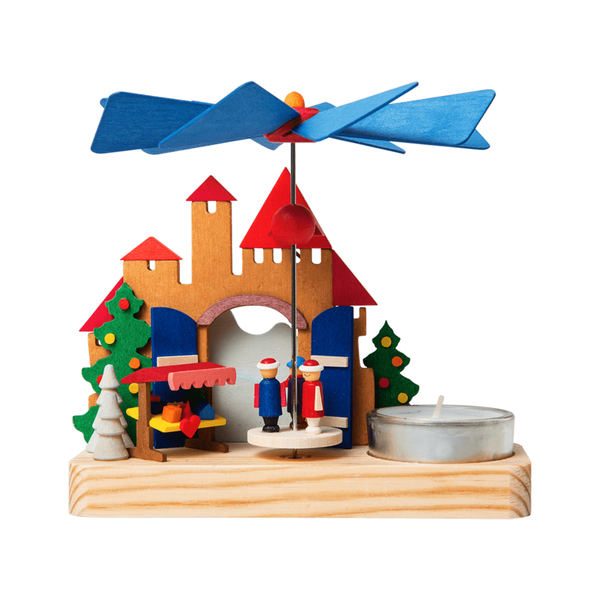 A small wooden pyramid featuring a Kristkindlemarket, with a single tea light candle.