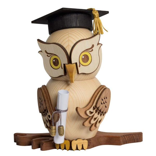 Wooden owl figurine incense smoker wearing a graduation cap and holding a diploma on a white background sitting on a tree branch by Drechslerei Kuhnert GmbH