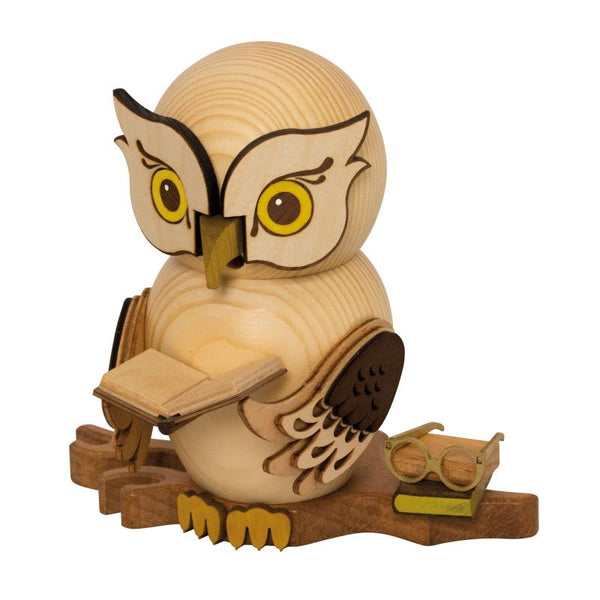 Wooden owl figurine incense smoker holding a book  and sitting beside another book and pair of glasses on a tree branch by Drechslerei Kuhnert GmbH