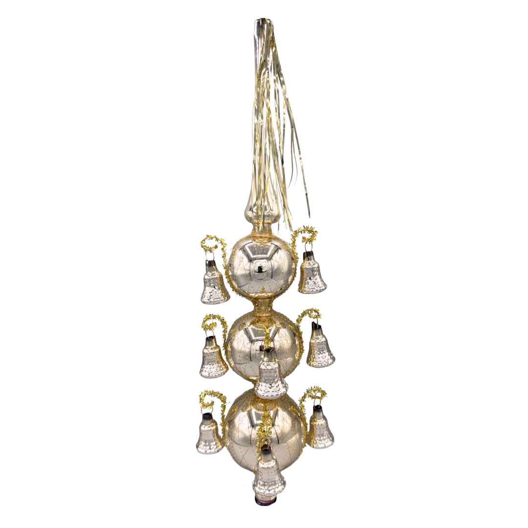 Decorative soft champagne gold blown glass finial tree topper, with three tiers of spheres with suspended bells and a tinsel tassel coming out of the pointed top.