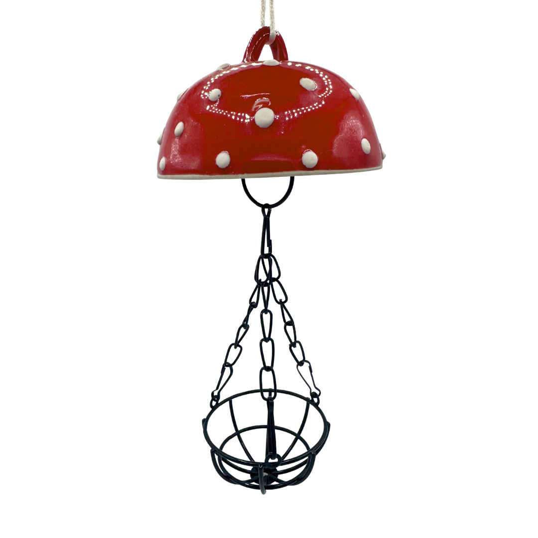 Red porcelain top with white dots and black chain on a white background