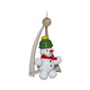Decorative snowman on a swing ornament with a green hat and red yarn scarf on a white background