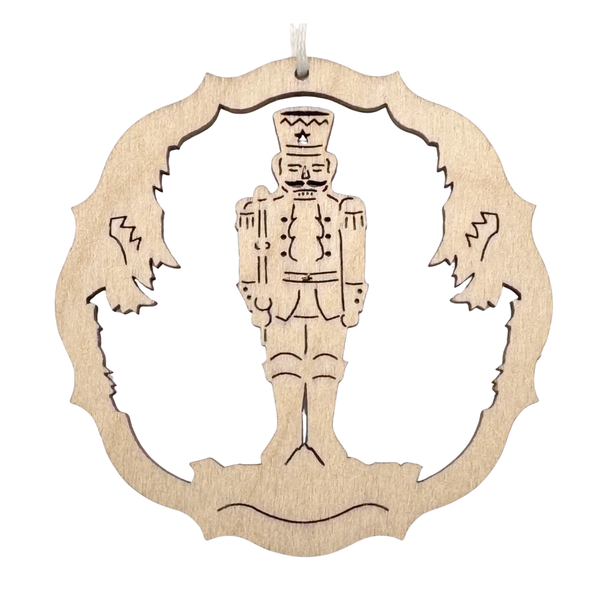 Wooden ornament with a nutcracker design on a white background