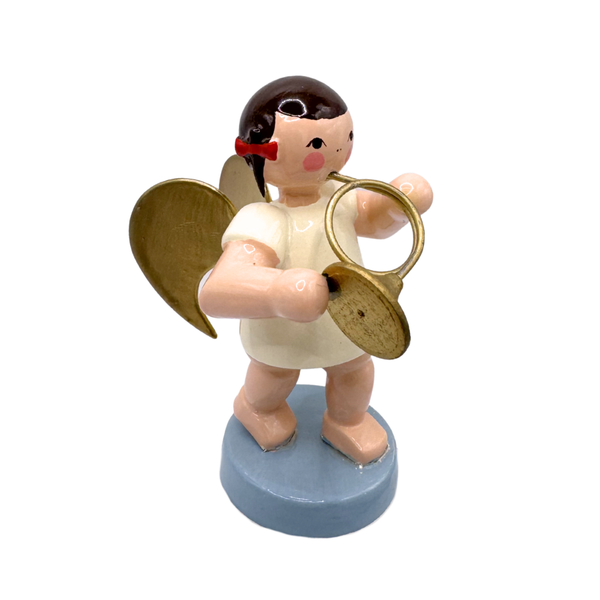 Miniature figure of an angel with gold wings playing a french horn on a blue base
