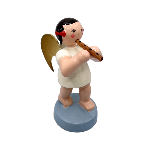Miniature figure of a standing angel with gold wings playing a flute on a blue base