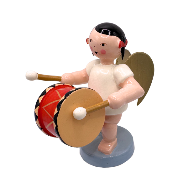Miniature figure of a standing angel with gold wings playing a bass drum on a blue base