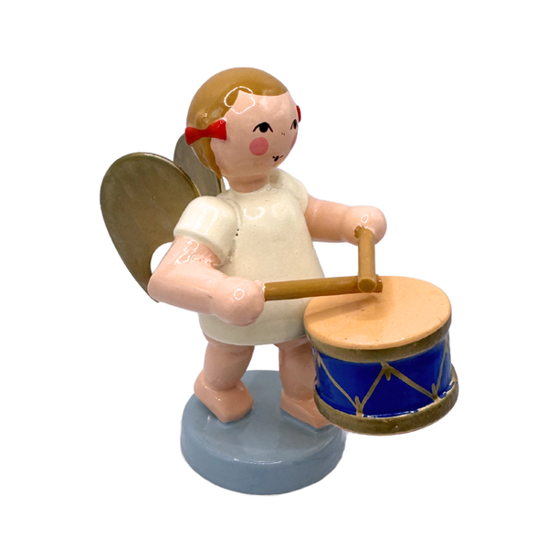 Miniature figure of a standing angel with gold wings playing a drum on a blue base