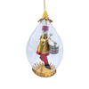 A clear teardrop-shaped hanging ornament containing a small gold-and-red toy soldier figure with a drum, suspended by a gold string against a white background.