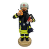 A handcrafted wooden incense smoker figure dressed as a firefighter in black tunic, holding a hose and a phone, with a helmet on head.